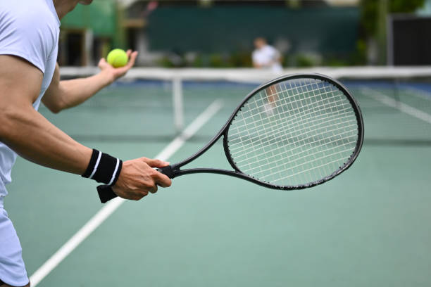 Professional tennis coach demonstrating perfect technique on court
